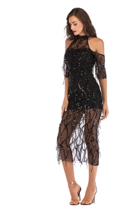 Detail of black sequin tassel dress with sheer mesh sleeves and halter neck design