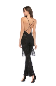 Close-up of sexy open back design with black sequins and fringe details on the jumpsuit