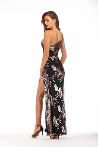 Detail view of the rose gold sequin embroidery and high slit on this elegant black gown