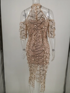 Detailed back view of champagne sequin dress with sheer mesh and a halter neckline