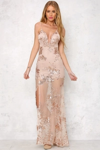 Close-up of champagne sequin embroidery on backless evening dress with a high side slit