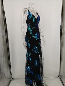 Detail of black sequin evening gown with blue-green peacock feather embroidery and high slit