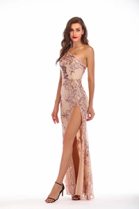 Detail shot of champagne sequin evening gown showing the high slit and asymmetric shoulder