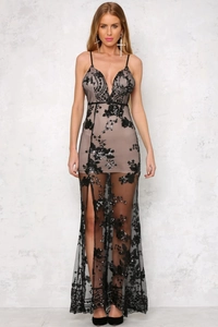 Detail of black sequin lace dress featuring high slit and sheer floral embroidery