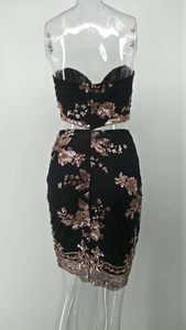 Detail view of the back of a black two-piece sequin set with rose gold floral patterns