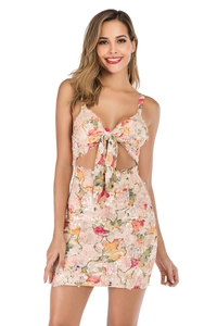 Close-up of pink floral sequin dress featuring cut-out waist and bow tie detail