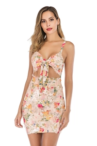 Close-up of pink floral sequin dress featuring waist cut-out and bow tie detail