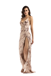Detail of rose gold sequin floral embroidery on a champagne evening dress with high slit