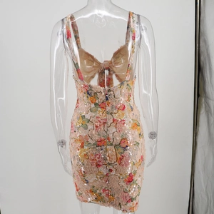 Close-up of pink floral sequin dress featuring a large 3D bow on the open back