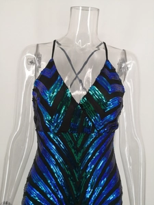 Close-up of sparkling blue and green sequins in a V-pattern on the black party dress