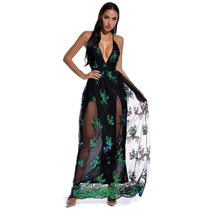 Detailed view of deep V-neckline and shiny blue-green sequins on black mesh evening dress