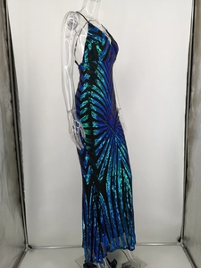 Detail of emerald green and navy sequined evening gown with geometric radiating patterns