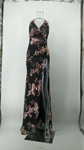 Detail of sequin floral pattern on a black evening gown with side slit and floor length