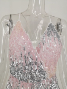 Macro shot of pink and silver sequins with elegant white lace trim on the V-neckline