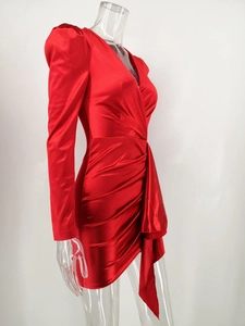 Detail of red satin mini dress featuring V-neck, puff sleeves and elegant draped pleats