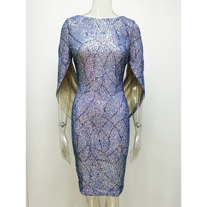 Detailed close-up of blue sequin fabric with sparkling textures on a cape sleeve dress