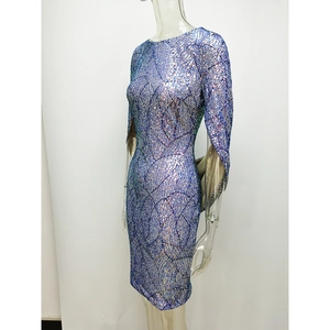 Detail of blue sequin dress featuring wavy texture and split cape sleeve design