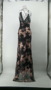 Detail of black evening gown featuring rose gold sequin rose embroidery and sheer tulle hem