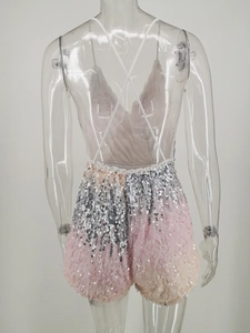 Detail of pink and silver sequin romper featuring a cross-back backless design on a mannequin