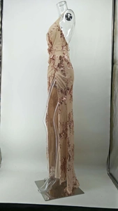 Detail of rose gold sequin floral embroidery on a backless high-slit evening dress