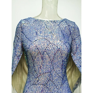 Detail of blue purple sequins dress showing geometric stitching and cape sleeves texture
