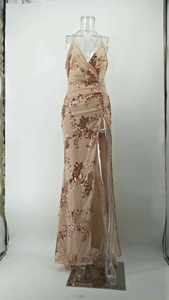 Detail of champagne evening dress with rose gold sequins and high leg slit feature