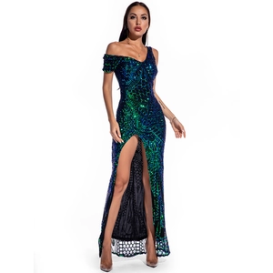 Detail view of blue-green gradient sequin embroidery and high slit on a sleek evening dress