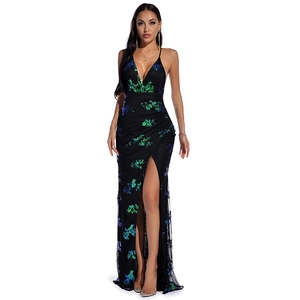 Detail of evening gown with green and blue sequins, side slit and black mesh inserts