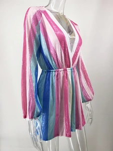 Detail of the deep V-neck and colorful sequin stripes on this long sleeve romper