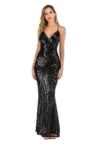 Detail of silver sequin patterns on a black V-neck backless evening gown fabric