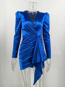 Detail of sapphire blue satin dress featuring deep V-neck, puff sleeves and draped waist