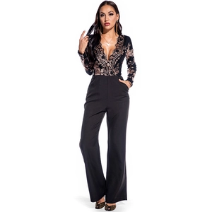 Close-up of deep V-neckline with gold sequin embroidery on black slim fit jumpsuit