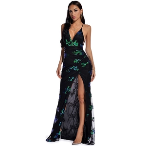 Detail of sequined long dress with thigh-high slit and delicate black lace trim