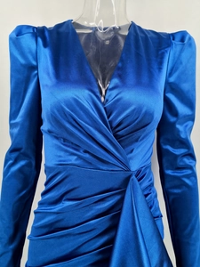 Detail of the navy blue satin dress with pleated waist design and smooth silk texture