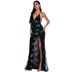 Detail of black mesh evening dress with green-blue gradient sequins and high slit