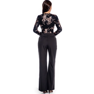 Sultry long sleeve jumpsuit featuring a gold sequin floral bodice and black wide leg pants