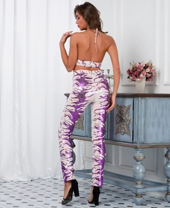 Rear view of backless halter top and tight trousers with purple tiger sequin patterns