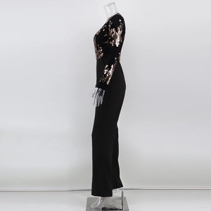Detail of black jumpsuit showing gold sequin floral pattern on sleeves and bodice