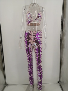 Detail of sequined halter neck top and high-waist trousers in purple zebra pattern