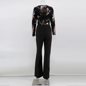 Detail view of the back zipper and sequined floral embroidery on a long sleeve jumpsuit