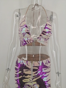 Detail of sequin halter top with tiger stripe pattern and decorative metal ring at center