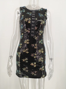 Close-up of star-shaped multicolor sequins and metal hook closure on slim black dress