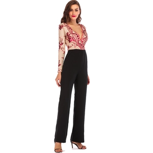 Detail of sequin floral pattern on beige deep V-neck bodice and black wide leg jumpsuit