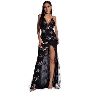 Detail view of the black evening dress with gold floral sequins and sexy high leg slit