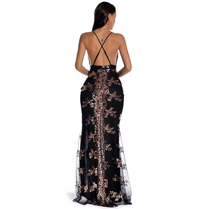 Detail view of backless sequin dress with cross-straps and gold embroidery on black fabric