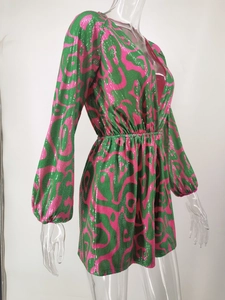 Close-up detail of sequined striped romper with lantern sleeves and vibrant wave pattern