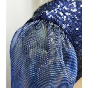 Detail of blue sequin patchwork on sexy mesh dress with metallic ribbed knit fabric