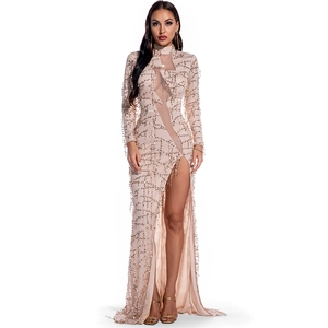 Detail of sheer mesh patchwork and sparkling sequins on a champagne evening gown