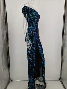Detail of blue-green gradient sequined dress featuring a high side slit and sequins