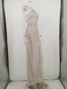 Detailed close-up of colorful sequins on long backless evening dress with pearly finish